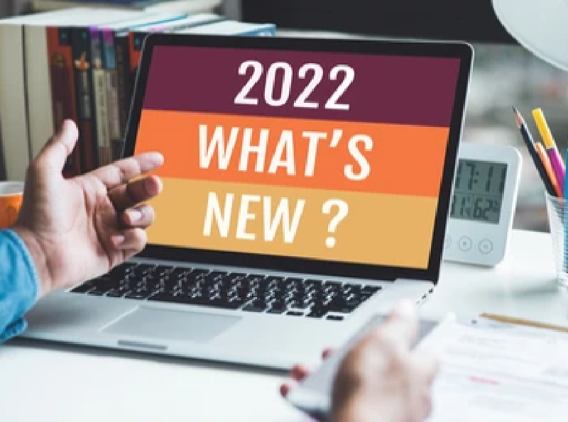 Image of man pointing at laptop screen that says 2022 What's New?